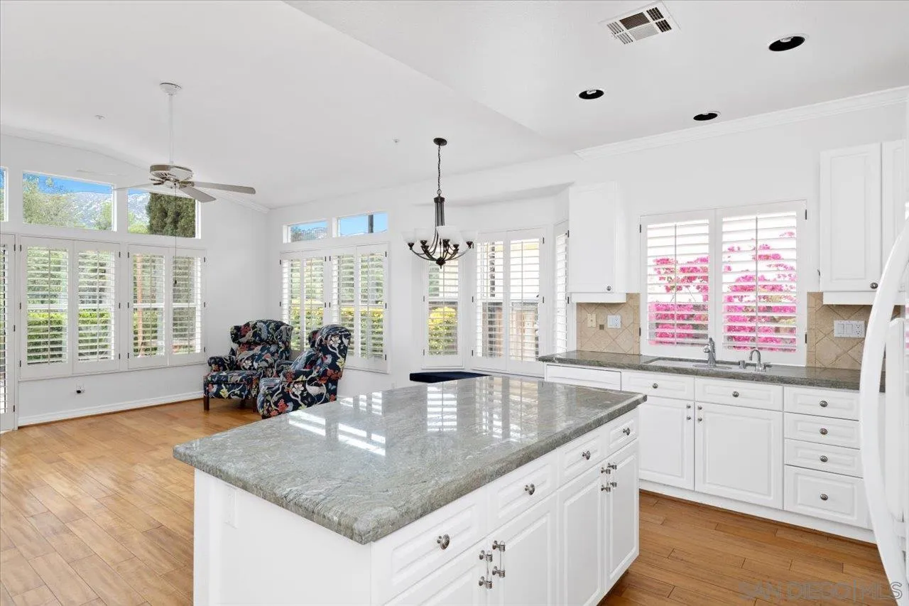 2314 Fallbrook Place Escondido, CA 92027 - Photo 11 of 30 a kitchen with granite countertop a sink a counter top space and living room view