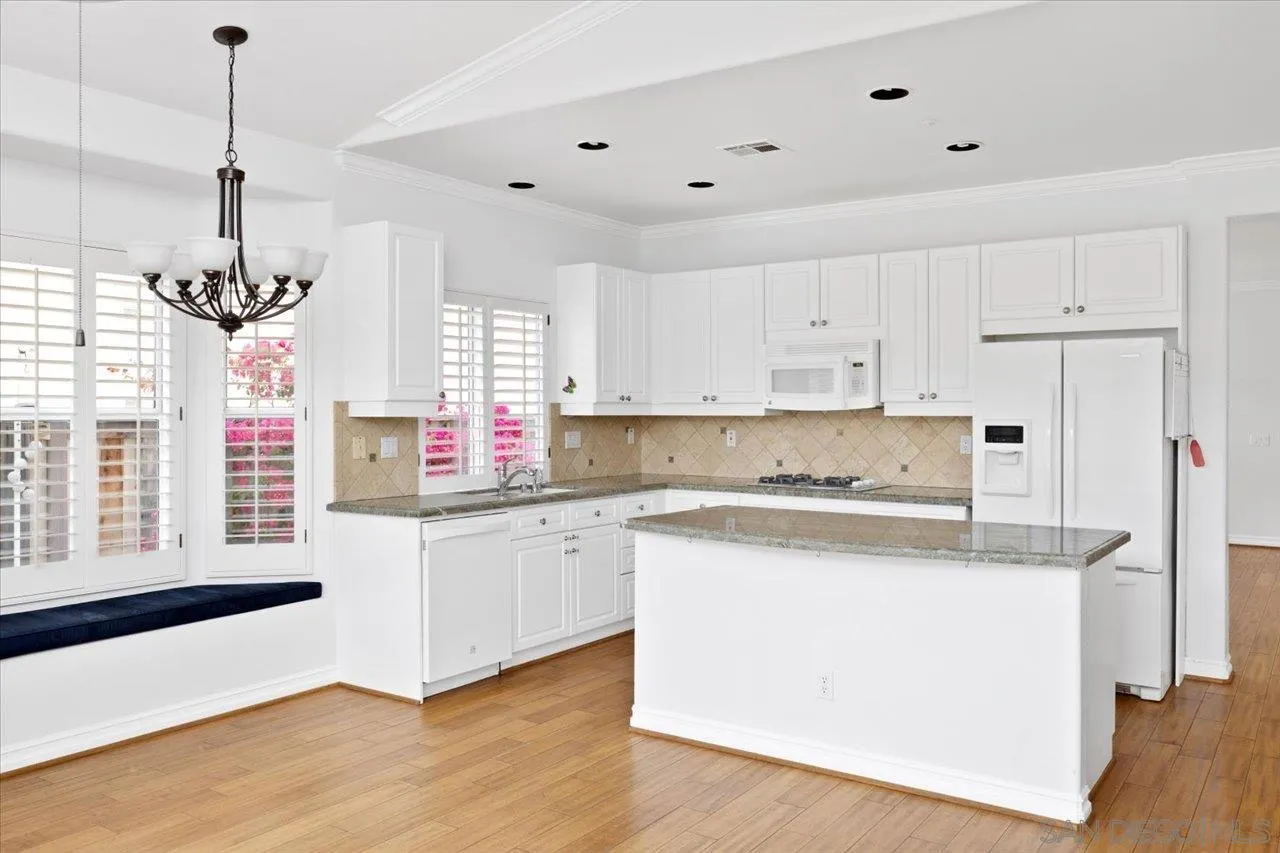 2314 Fallbrook Place Escondido, CA 92027 - Photo 12 of 30 a kitchen with stainless steel appliances granite countertop a stove a sink dishwasher a refrigerator and white cabinets with wooden floor