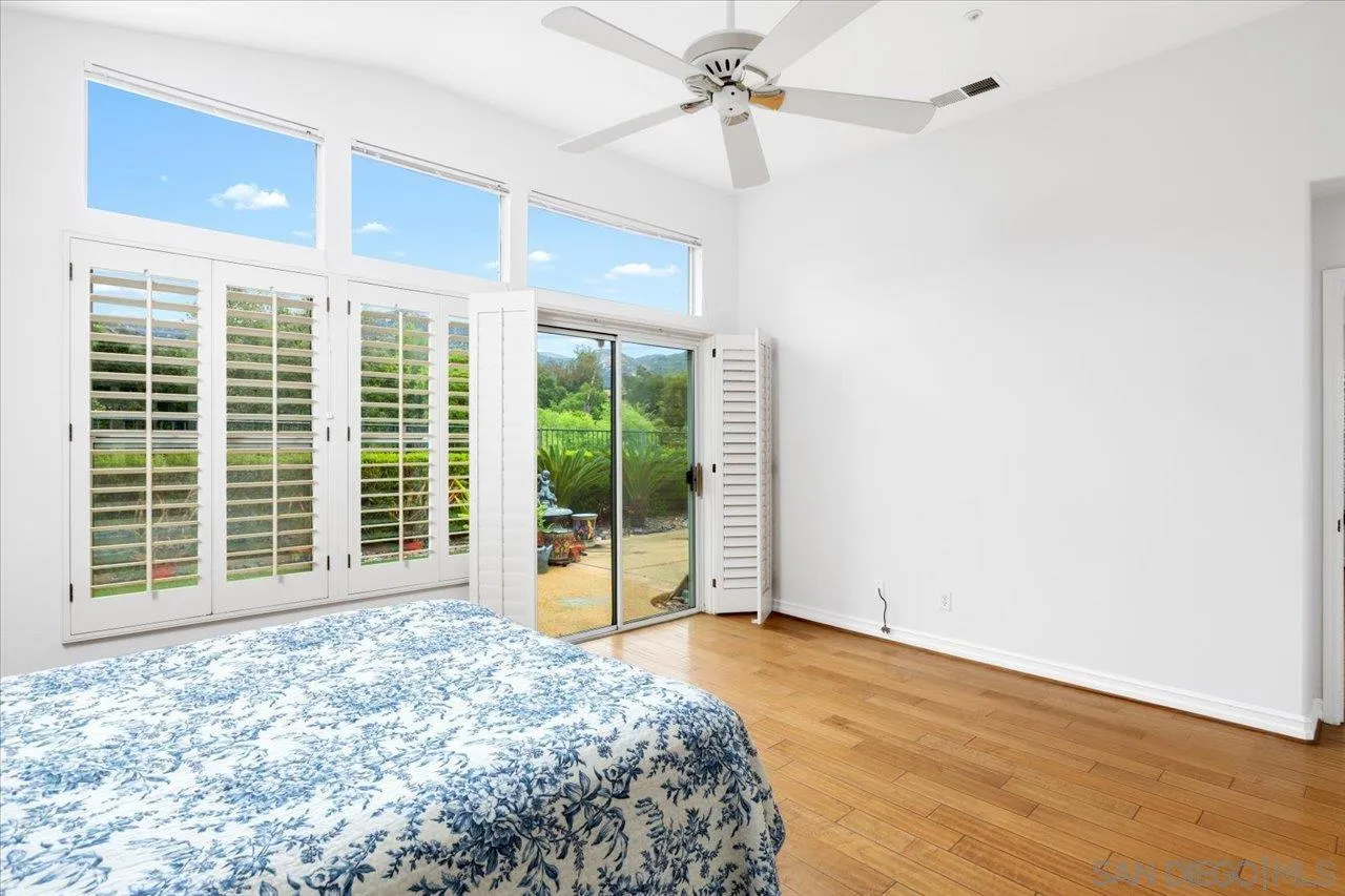 2314 Fallbrook Place Escondido, CA 92027 - Photo 20 of 30 a view of a livingroom with wooden floor and a ceiling fan