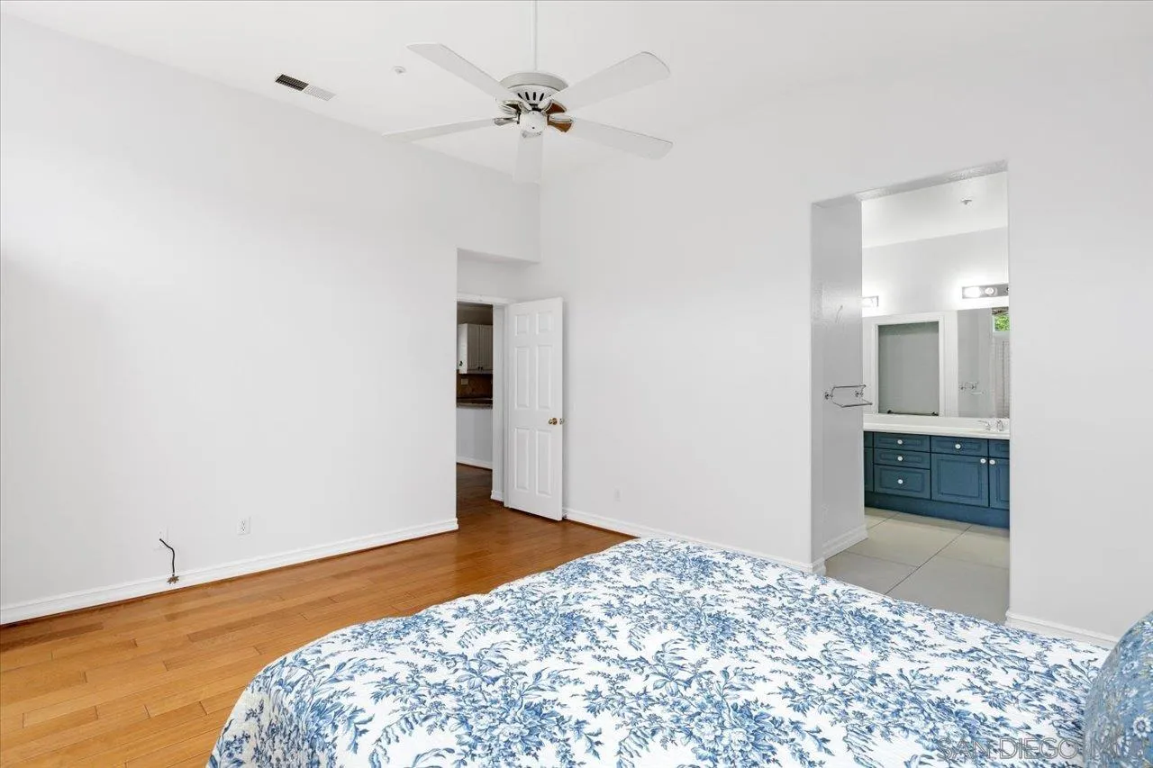 2314 Fallbrook Place Escondido, CA 92027 - Photo 21 of 30 a bedroom with a bed and a chandelier fan