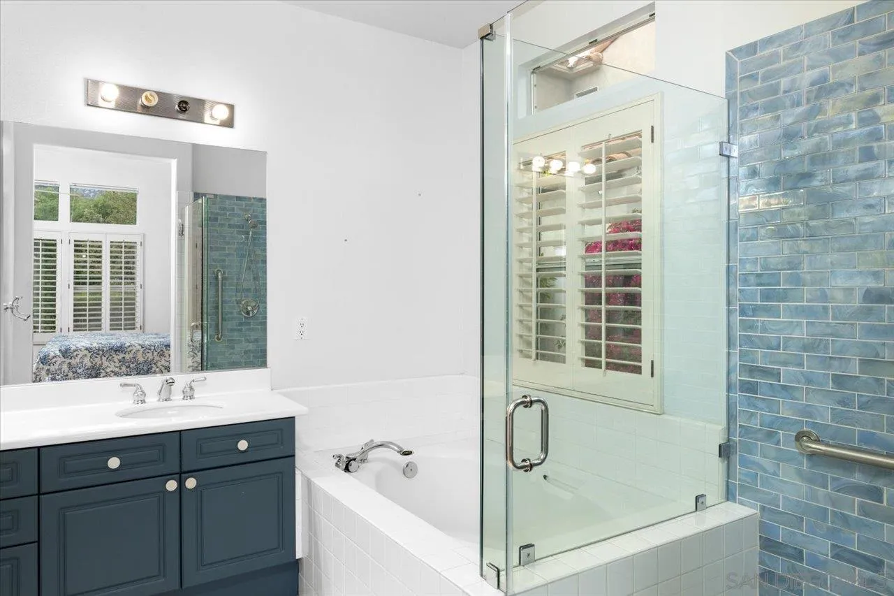 2314 Fallbrook Place Escondido, CA 92027 - Photo 23 of 30 a bathroom with a tub sink shower and two mirror