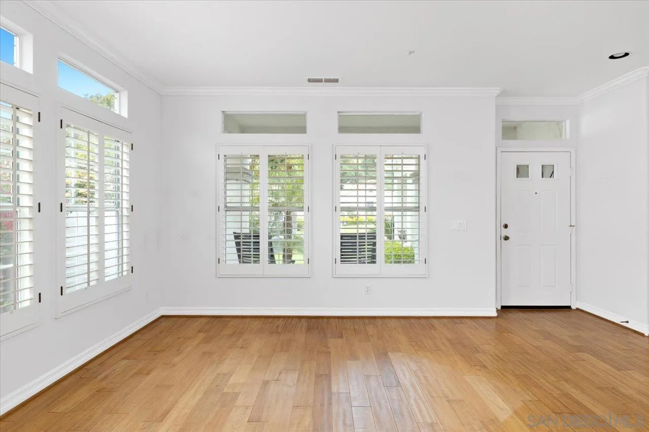 2314 Fallbrook Place Escondido, CA 92027 - Photo 7 of 30 a view of an empty room with wooden floor and a window