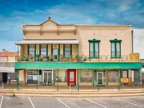 front view of a building with a garden