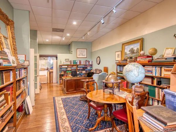 a living room with lots of furniture and kitchen view