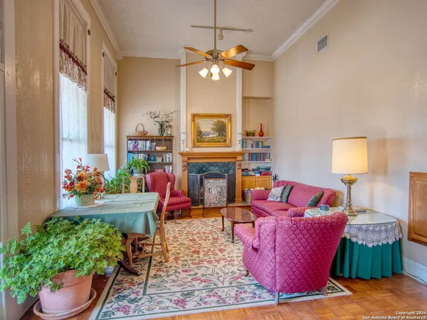 a view of a kitchen with kitchen island a large window cabinets a sink and stainless steel appliances