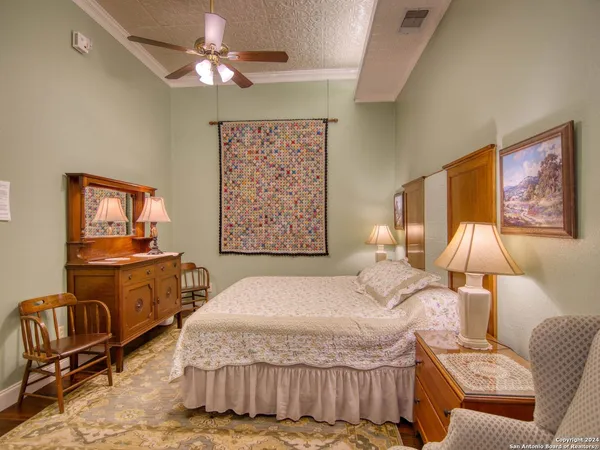 a bedroom with a bed and a painting on the wall