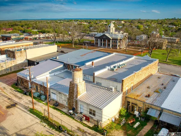 a car parked in front of building with large windows
