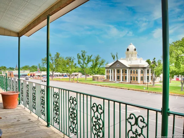 a view of a balcony with lake view and wooden floor