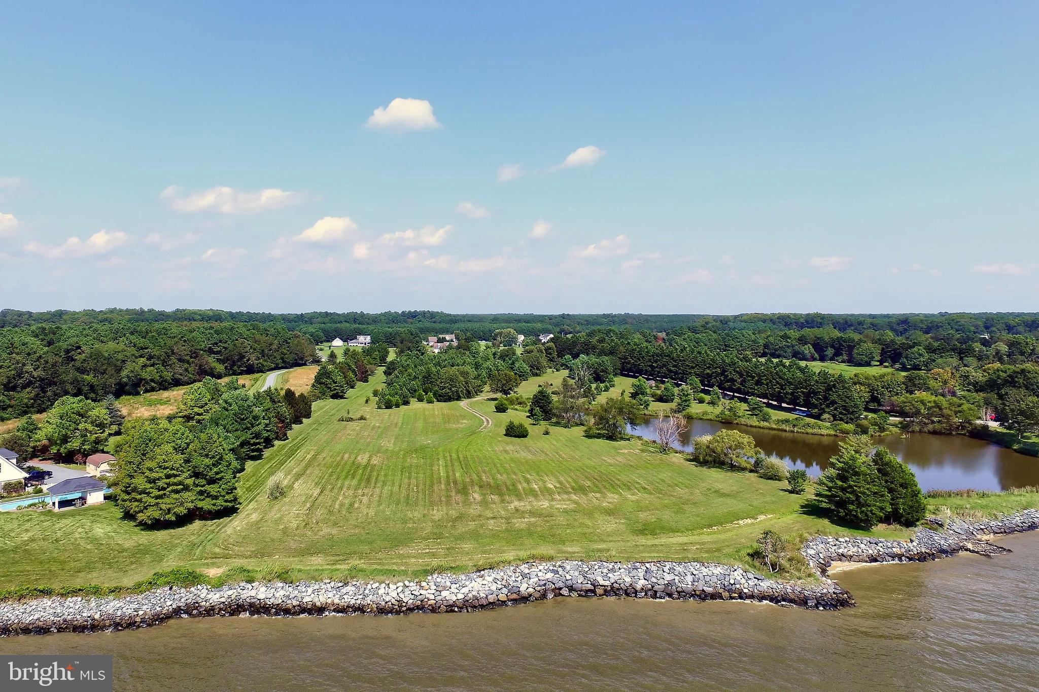 29569 Porpoise Creek Road Trappe, MD 21673 - Photo 7 of 25 a view of a lake with a houses