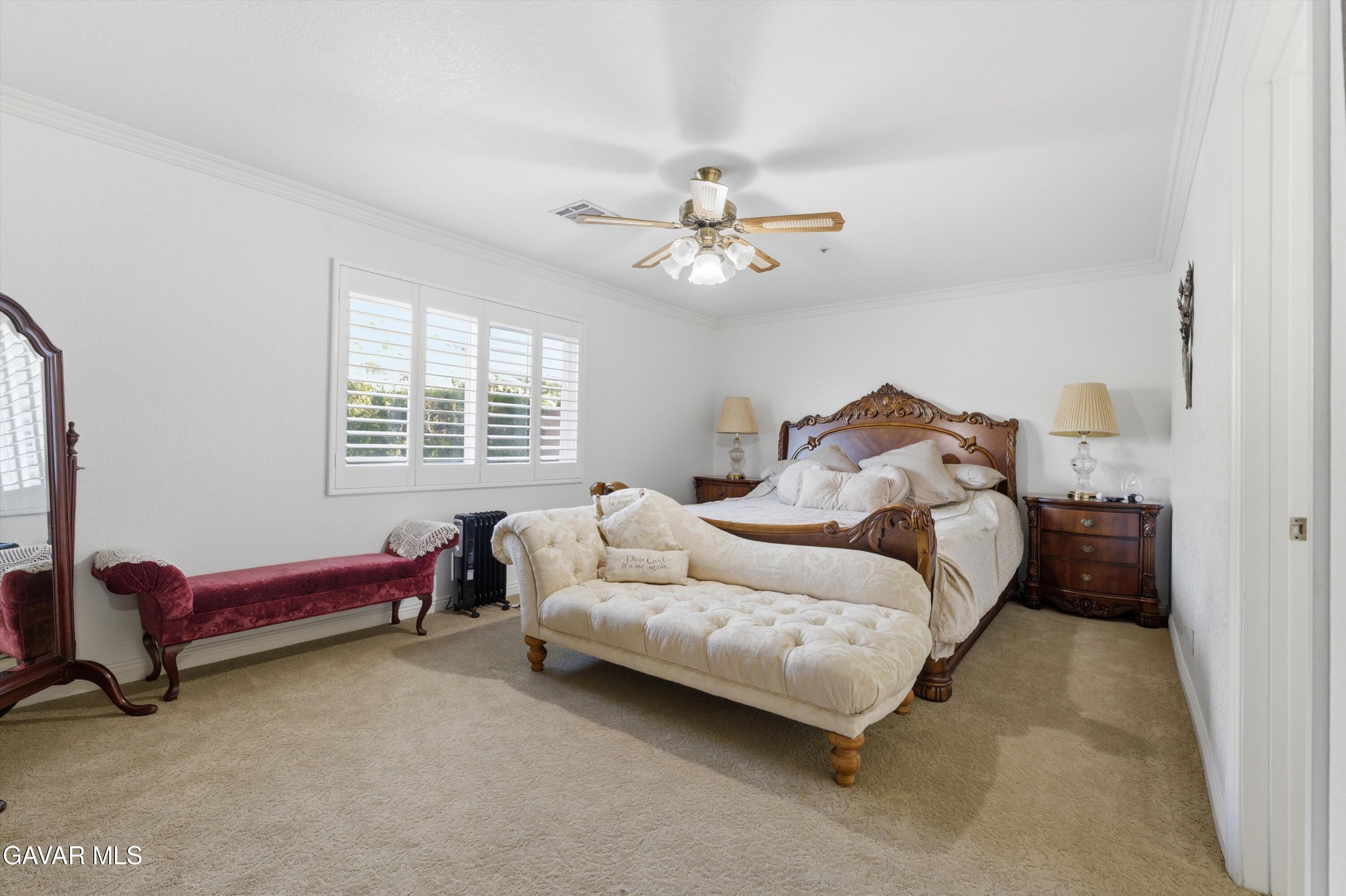 5801 Hacienda Ranch Road Palmdale, CA 93551 - Photo 34 of 69 a bedroom with a bed and a chandelier