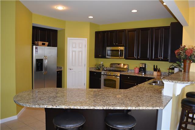 1046 Countess Lane Spring Hill, TN 37174 - Photo 2 of 14 Open kitchen with upgrades - granite, stainless steel, gas cooking and walk in pantry