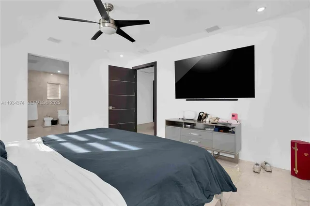 a bedroom with a bed and a flat screen tv