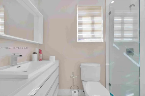 a bedroom with a bed and a ceiling fan