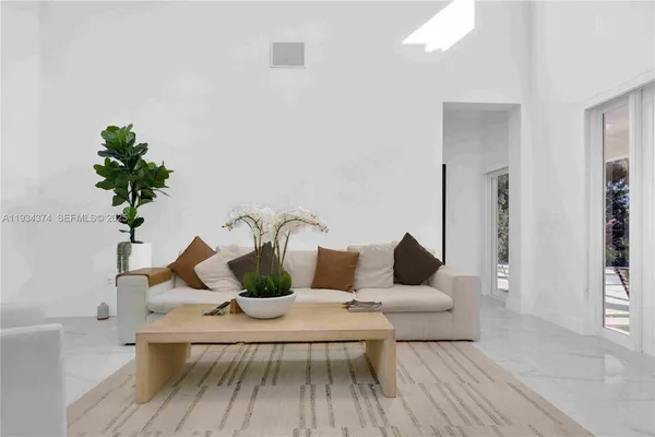 a kitchen with stainless steel appliances kitchen island granite countertop a refrigerator and a stove top oven