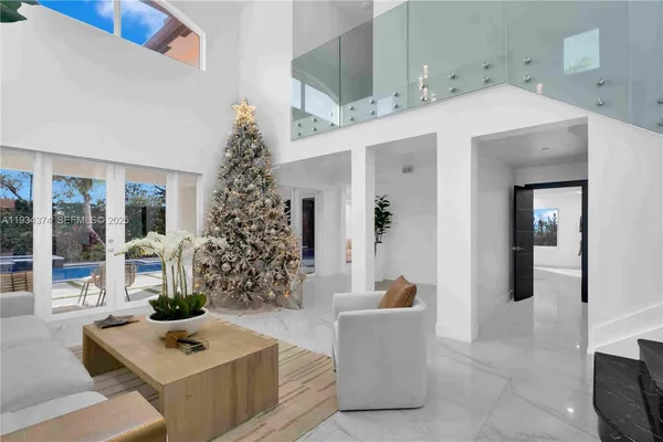 a living room with furniture and a chandelier