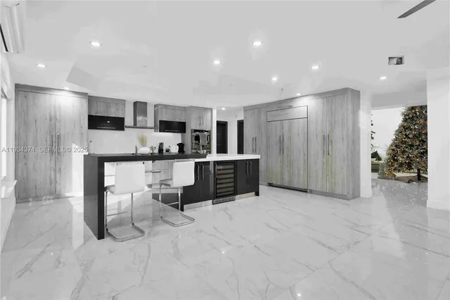 a kitchen with cabinets stainless steel appliances and sink