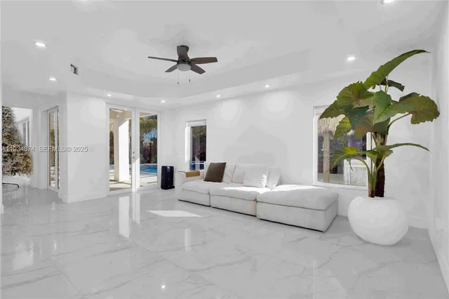 a living room with furniture and a potted plant