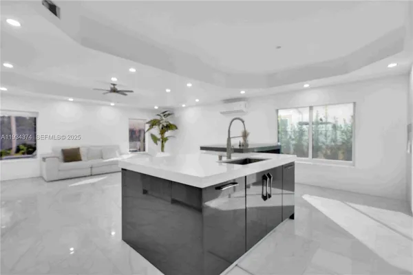 a room with pool table and windows