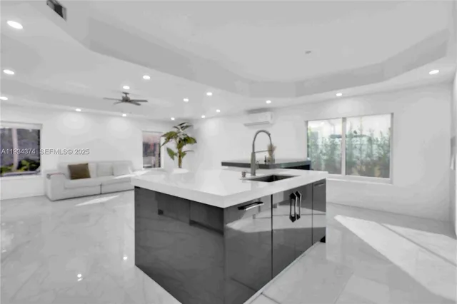 a room with pool table and windows