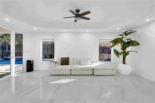 a view of a tennis ground with large trees