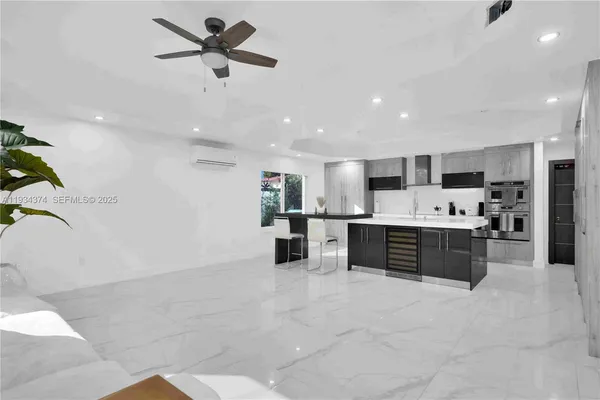 a view of a patio with table and chairs potted plants with wooden floor and fence