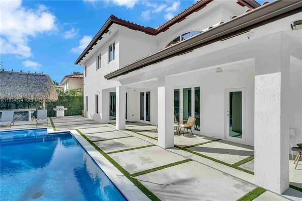 a view of house with backyard and outdoor seating