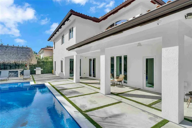 a view of house with backyard and outdoor seating