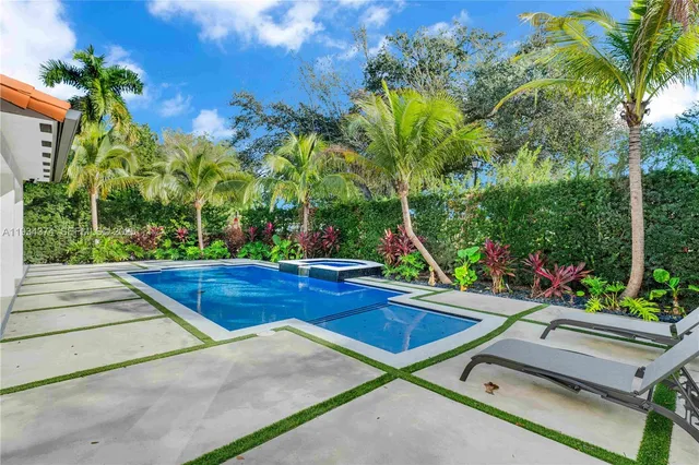 a view of a patio with swimming pool table and chairs