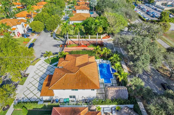 an aerial view of residential houses with outdoor space and swimming pool