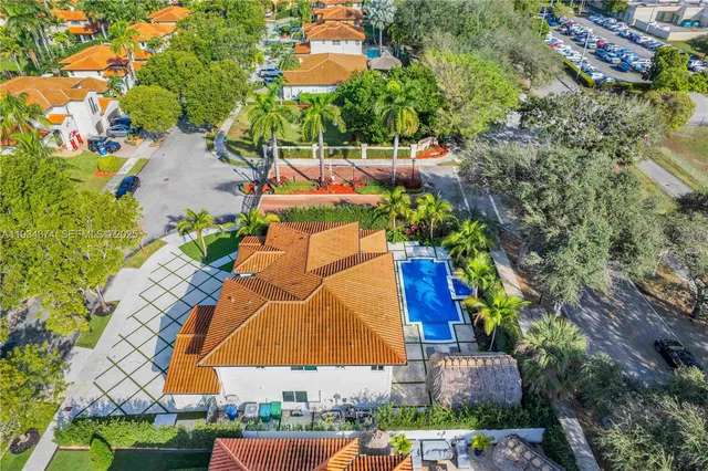 an aerial view of residential houses with outdoor space and swimming pool