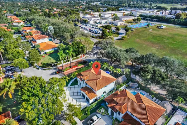 an aerial view of residential houses with outdoor space and swimming pool