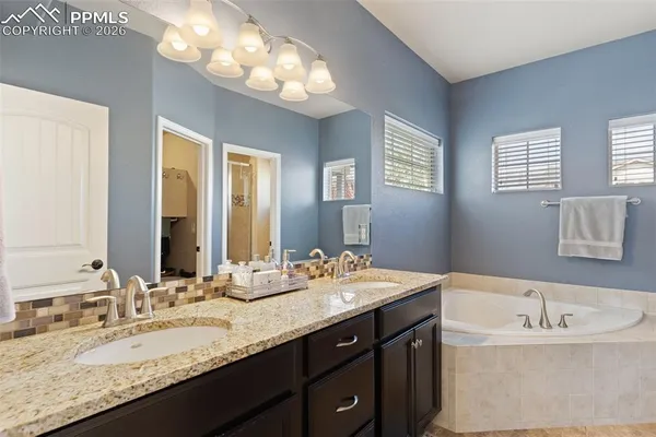 a bath tub sitting in a bathroom next to a window