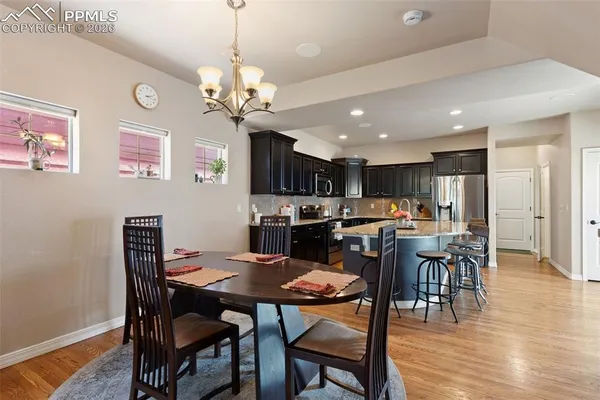 a view of a dining room with furniture and wooden floor
