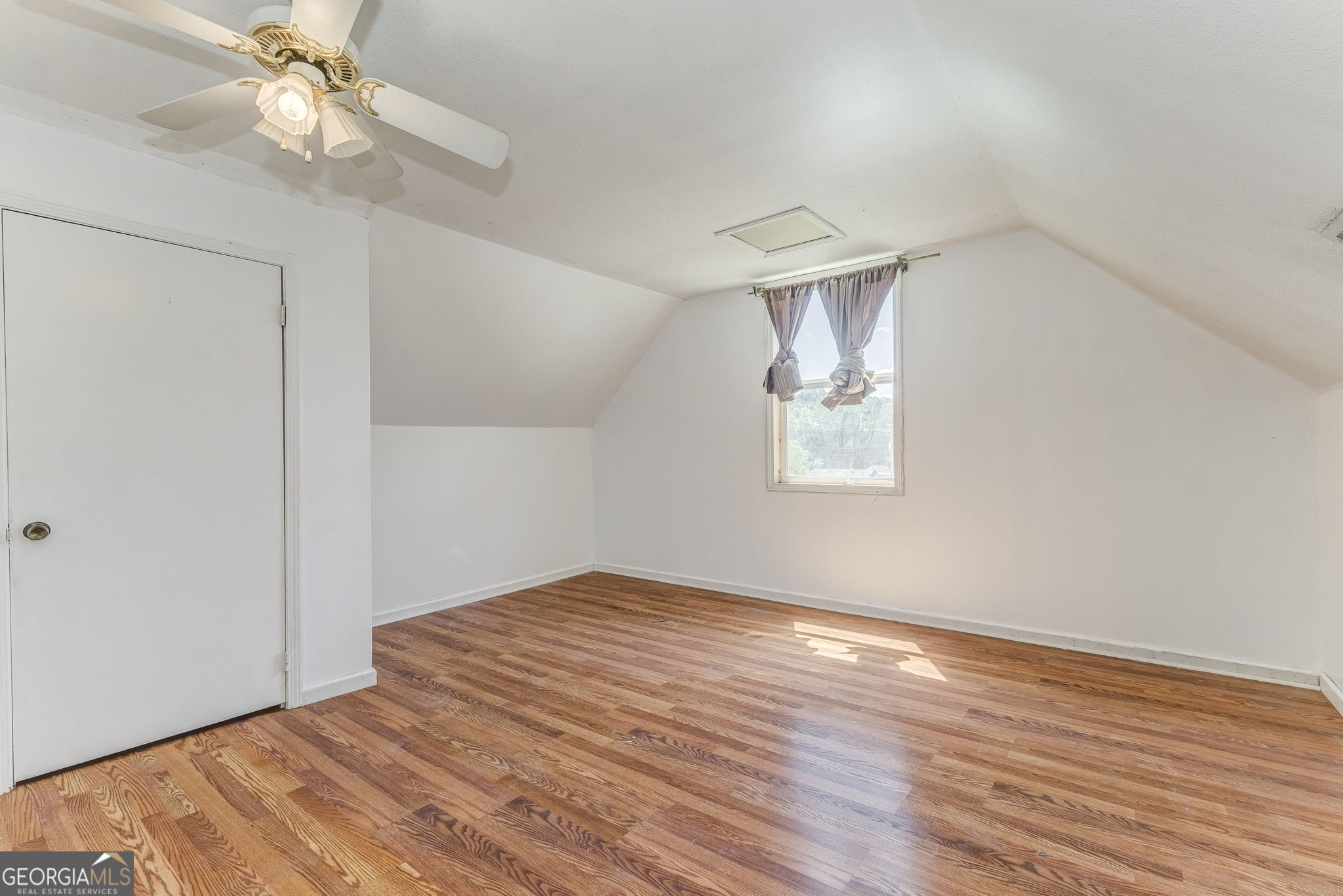 533 Underwood Street Dalton, GA 30721 - Photo 29 of 56 an empty room with wooden floor closet fan and windows