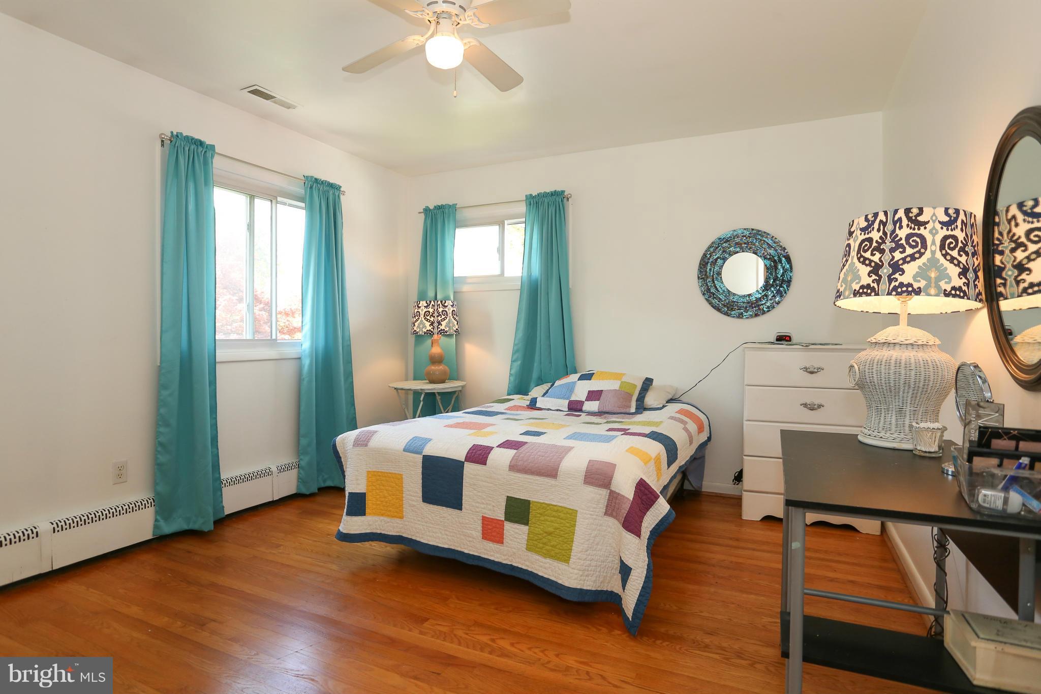 4013 High Point Road Ellicott City, MD 21042 - Photo 13 of 30 a bedroom with a bed and a chandelier