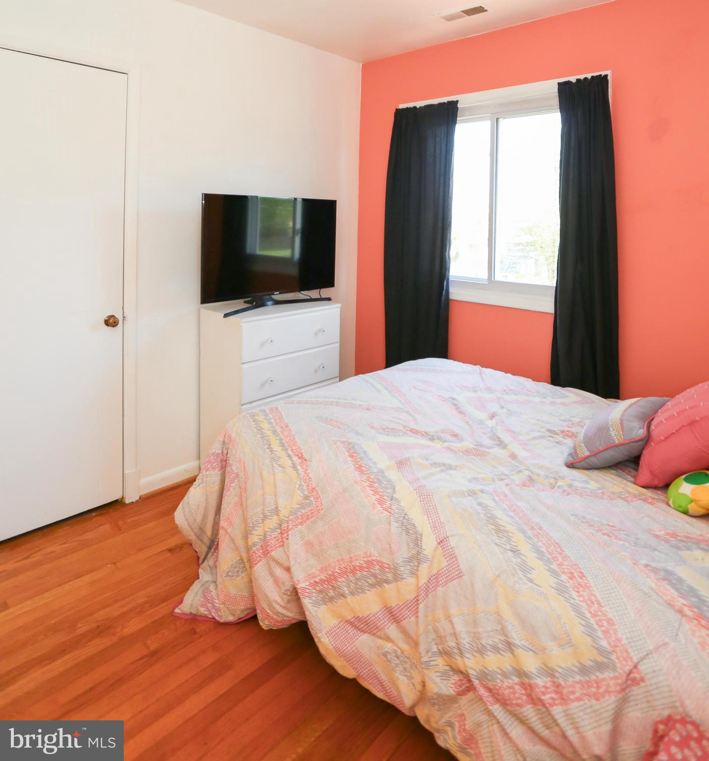 4013 High Point Road Ellicott City, MD 21042 - Photo 18 of 30 a bedroom with a bed tv and wooden floor