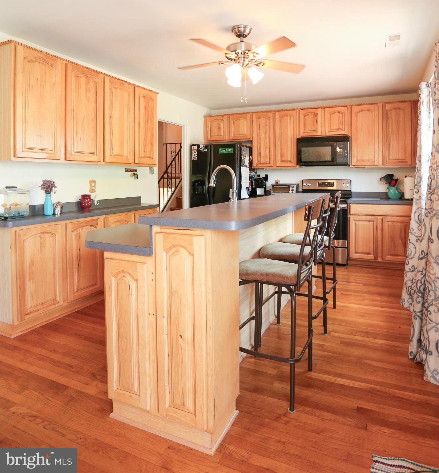 4013 High Point Road Ellicott City, MD 21042 - Photo 5 of 30 a view of kitchen with stainless steel appliances wooden floor large window and wooden cabinets