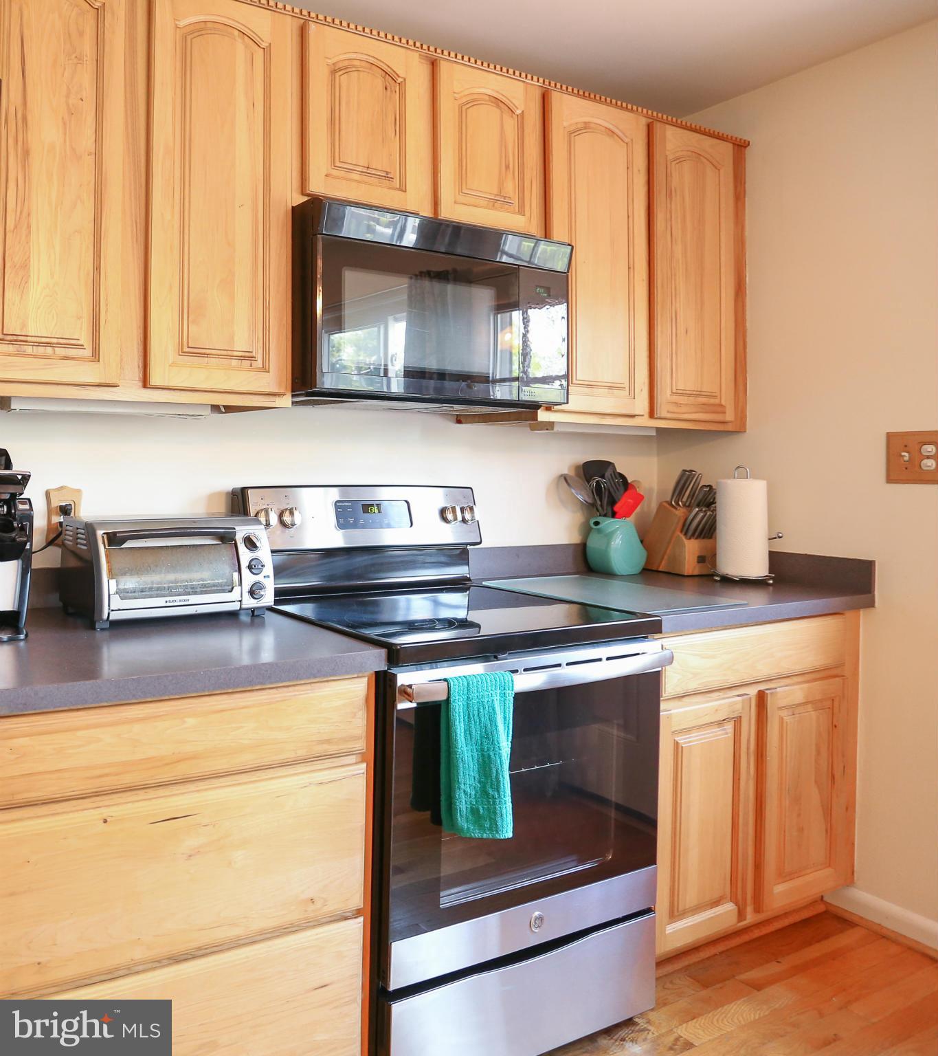 4013 High Point Road Ellicott City, MD 21042 - Photo 6 of 30 a kitchen with stainless steel appliances granite countertop a stove a microwave and a sink
