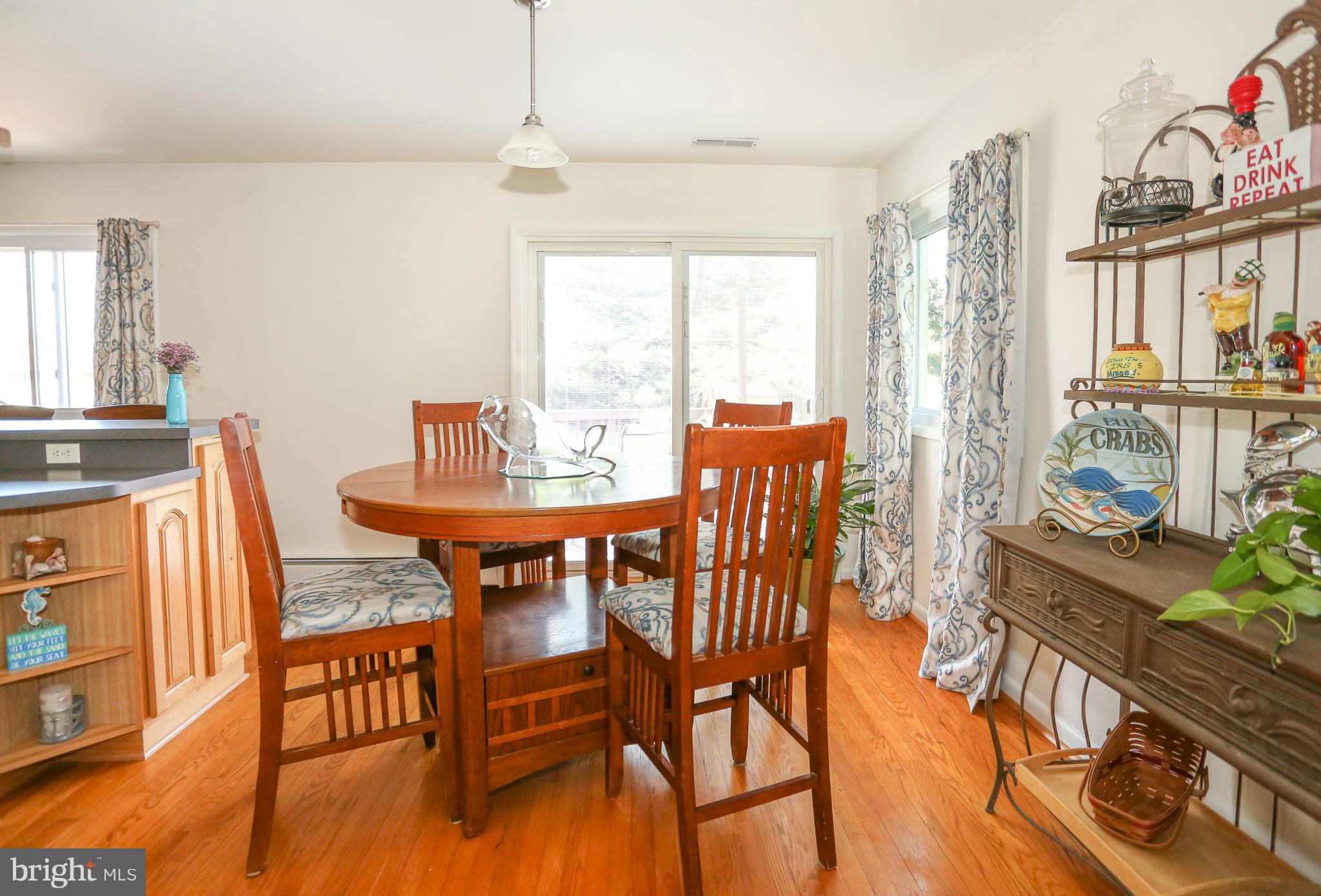 4013 High Point Road Ellicott City, MD 21042 - Photo 8 of 30 a dining room with furniture a chandelier and wooden floor