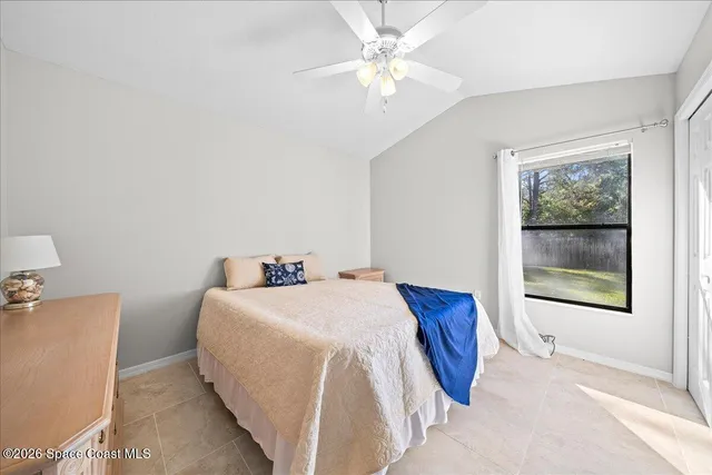 a bedroom with a bed and a ceiling fan