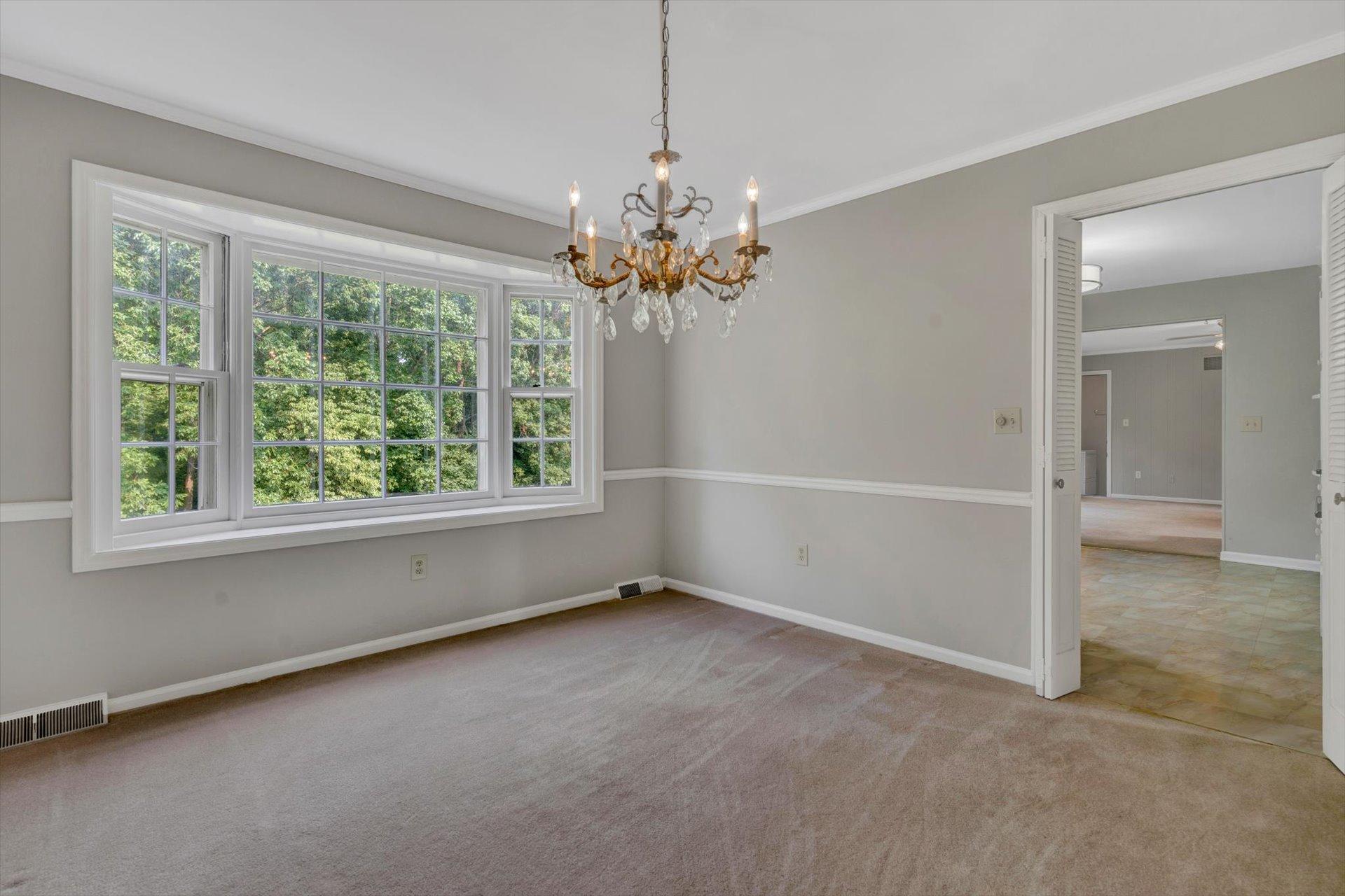 5157 Falcon Ridge Road Roanoke, VA 24018 - Photo 17 of 50 an empty room with windows and chandelier