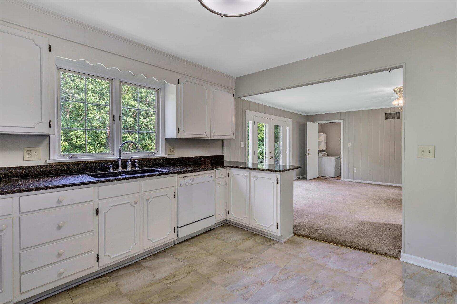 5157 Falcon Ridge Road Roanoke, VA 24018 - Photo 18 of 50 a open kitchen with granite countertop a sink and white cabinets