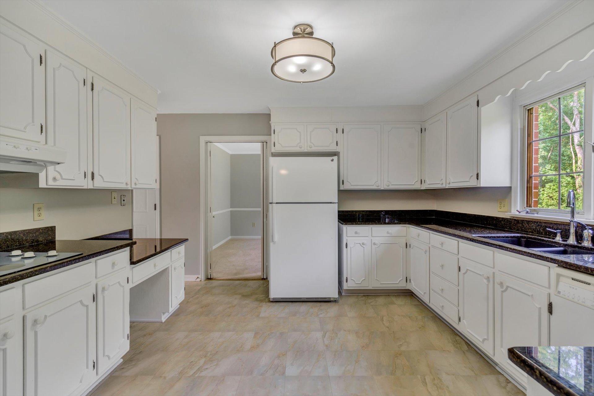 5157 Falcon Ridge Road Roanoke, VA 24018 - Photo 19 of 50 a kitchen with cabinets and a refrigerator
