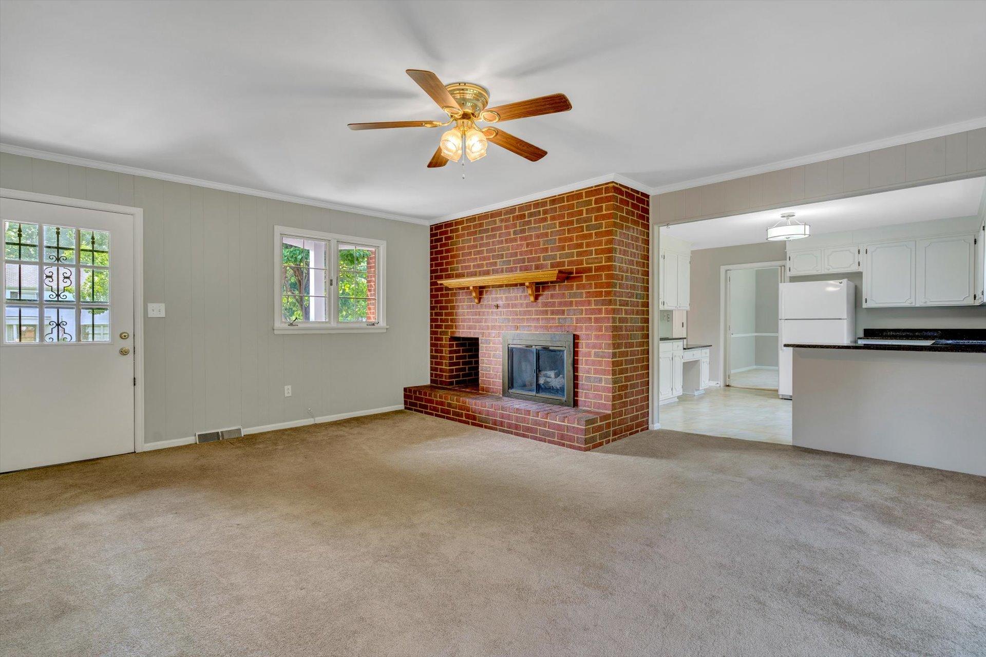 5157 Falcon Ridge Road Roanoke, VA 24018 - Photo 22 of 50 a view of a livingroom with a fireplace and a ceiling fan