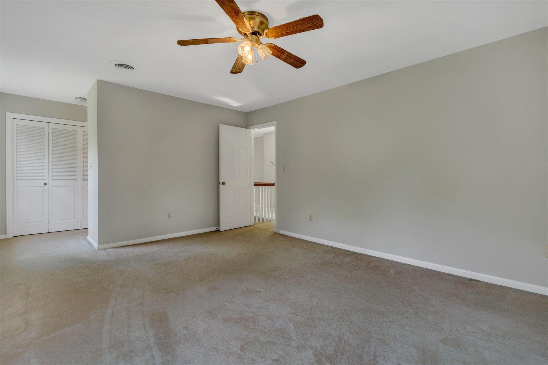 5157 Falcon Ridge Road Roanoke, VA 24018 - Photo 36 of 50 an empty room with a chandelier fan and a ceiling fan