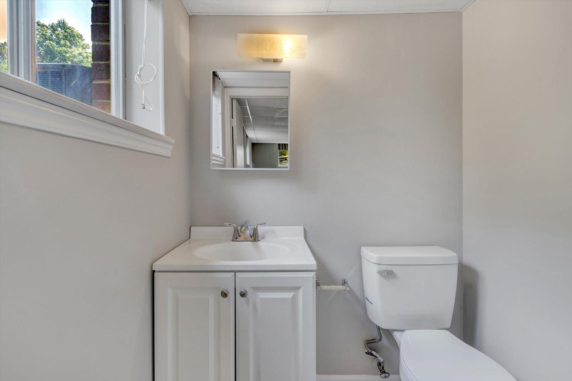 5157 Falcon Ridge Road Roanoke, VA 24018 - Photo 44 of 50 a bathroom with a toilet sink and mirror