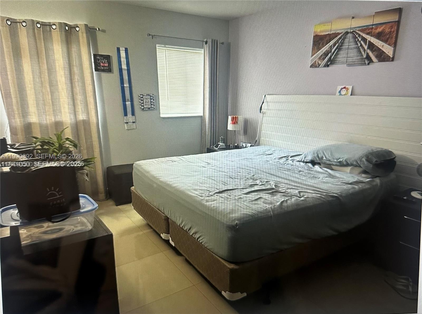 13810 Southwest 112th Street, Unit 106 Miami, FL 33186 - Photo 12 of 20 a bedroom with a bed and a window