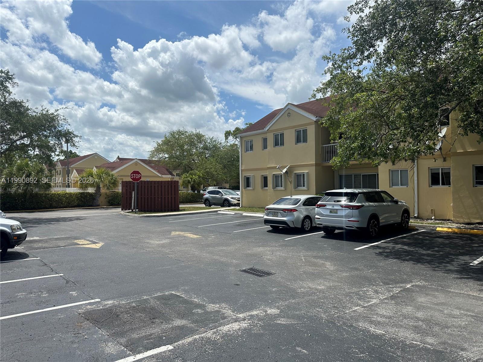 13810 Southwest 112th Street, Unit 106 Miami, FL 33186 - Photo 17 of 20 a car parked in front of a house