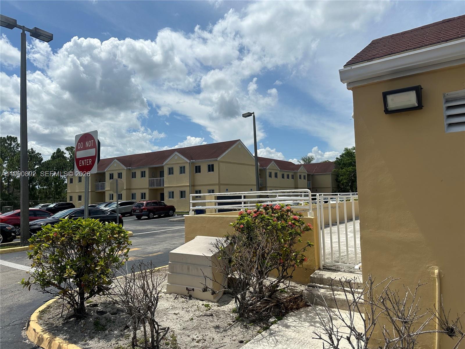 13810 Southwest 112th Street, Unit 106 Miami, FL 33186 - Photo 18 of 20 a street view with sitting space and garden view