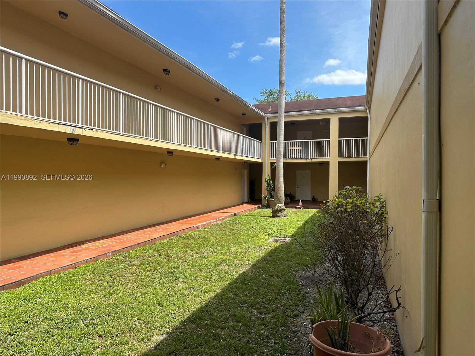 13810 Southwest 112th Street, Unit 106 Miami, FL 33186 - Photo 2 of 20 a house view with a garden space